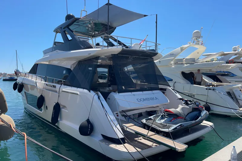  Yacht Photos Pics 2025 Ferretti Yachts 670 docked with jet ski, showcasing luxury design and features.