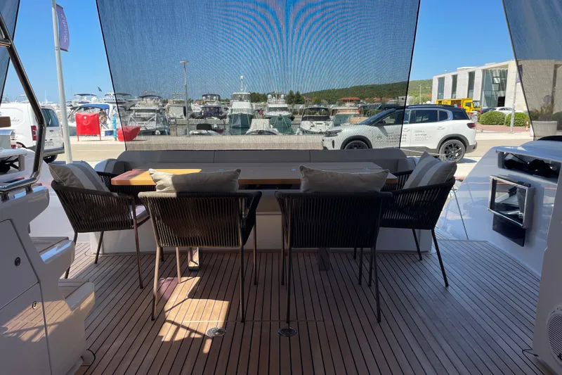  Yacht Photos Pics Luxurious 2025 Ferretti Yachts 670 deck with elegant seating and marina view.