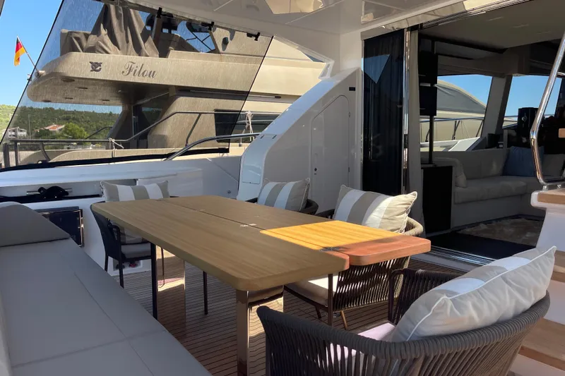 Yacht Photos Pics Luxurious 2025 Ferretti Yachts 670 with elegant outdoor seating and modern interior design.