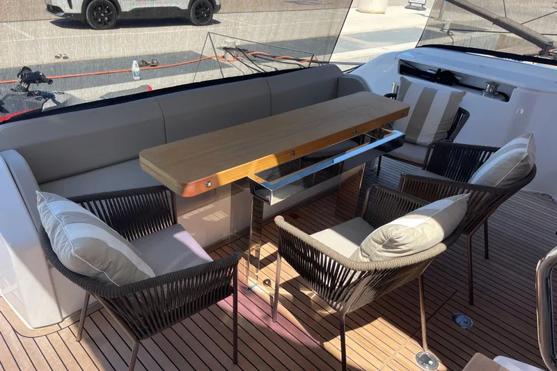  Yacht Photos Pics Luxurious seating area on 2025 Ferretti Yachts 670 with elegant table and cushions.