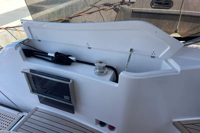  Yacht Photos Pics 2025 Ferretti Yachts 670 deck storage compartment with open lid and winch.