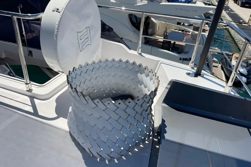  Yacht Photos Pics Ferretti Yachts 670 (2025) deck with stylish woven basket and railing.