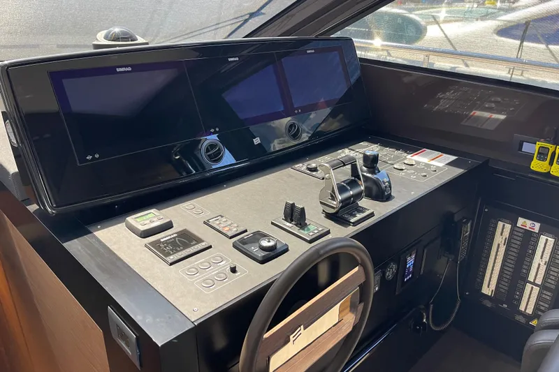  Yacht Photos Pics Cockpit of 2025 Ferretti Yachts 670 with advanced navigation controls and dual screens.