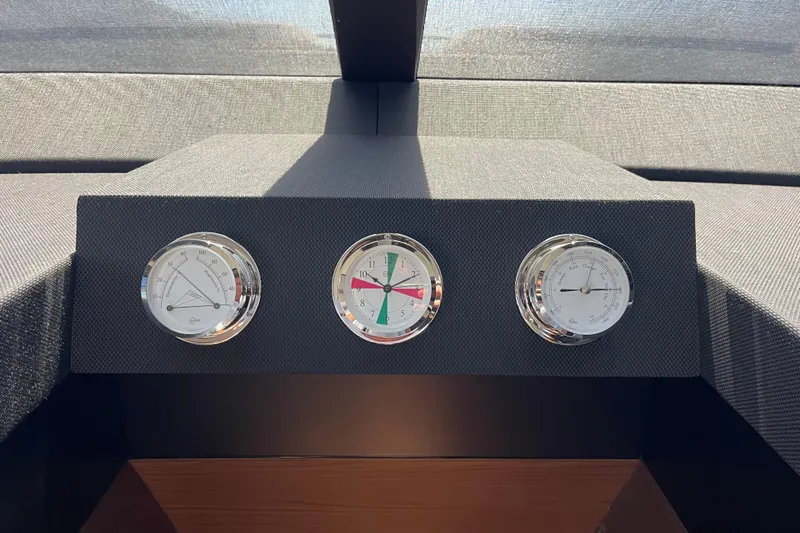 Yacht Photos Pics Instrument panel on 2025 Ferretti Yachts 670, featuring temperature, clock, and barometer gauges.