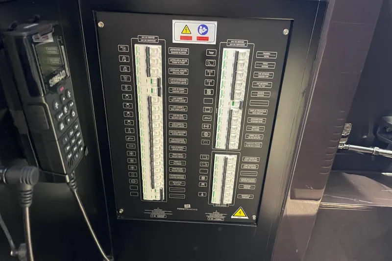  Yacht Photos Pics Electrical panel on a 2025 Ferretti Yachts 670, featuring circuit breakers and controls.