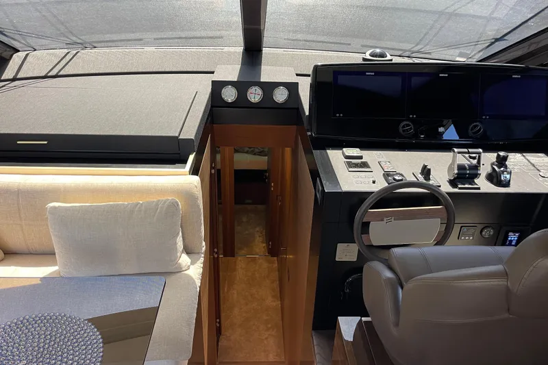  Yacht Photos Pics Luxurious interior of 2025 Ferretti Yachts 670, featuring modern helm and seating area.