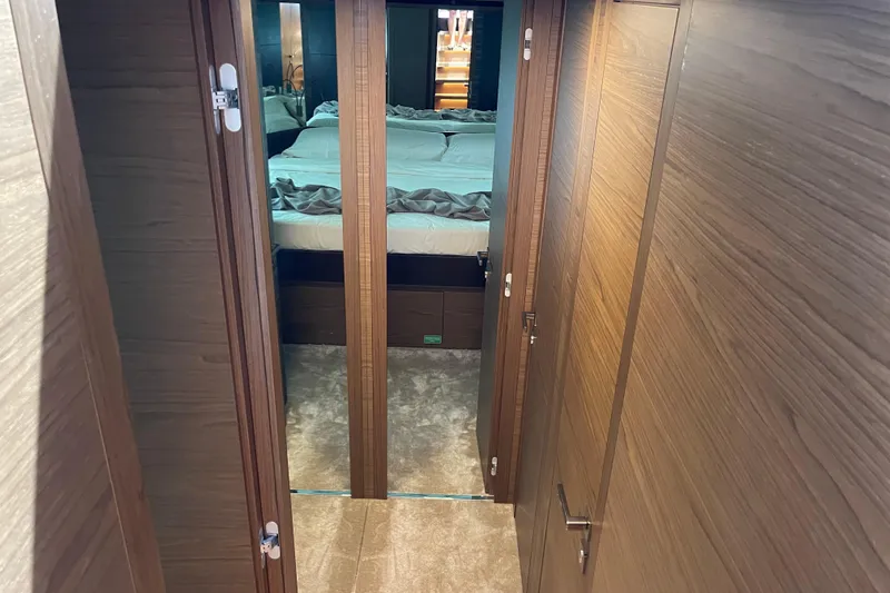  Yacht Photos Pics Luxurious interior of 2025 Ferretti Yachts 670, featuring elegant wood paneling and cozy bedroom.