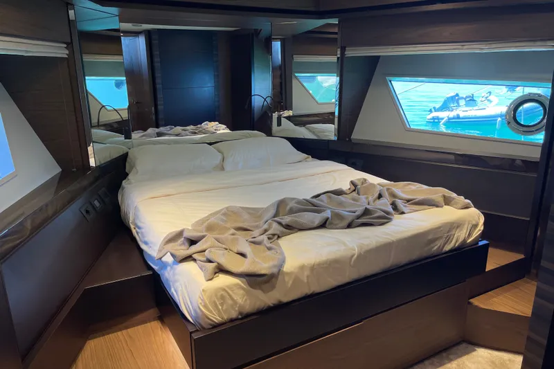  Yacht Photos Pics Luxurious bedroom interior of 2025 Ferretti Yachts 670 with elegant bedding and ocean view.