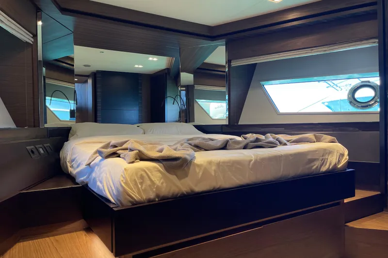  Yacht Photos Pics Luxurious bedroom interior of 2025 Ferretti Yachts 670 with modern design and large windows.
