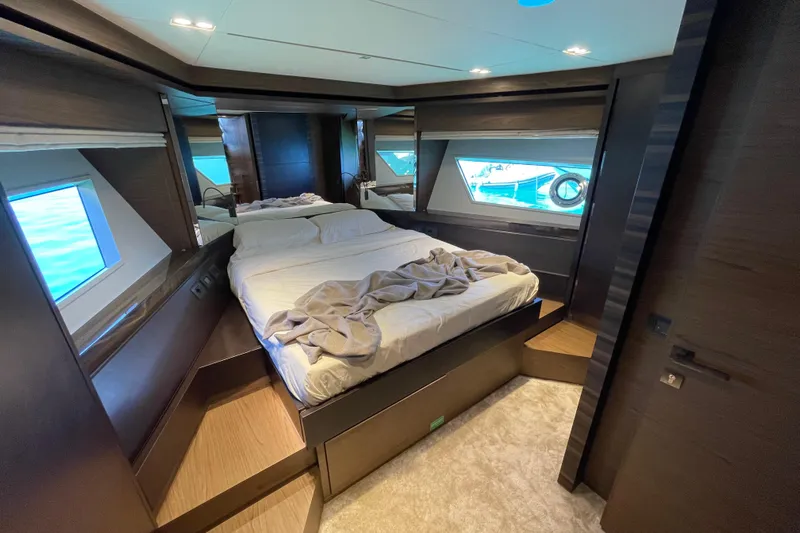  Yacht Photos Pics Luxurious bedroom interior of 2025 Ferretti Yachts 670 with modern design and large windows.