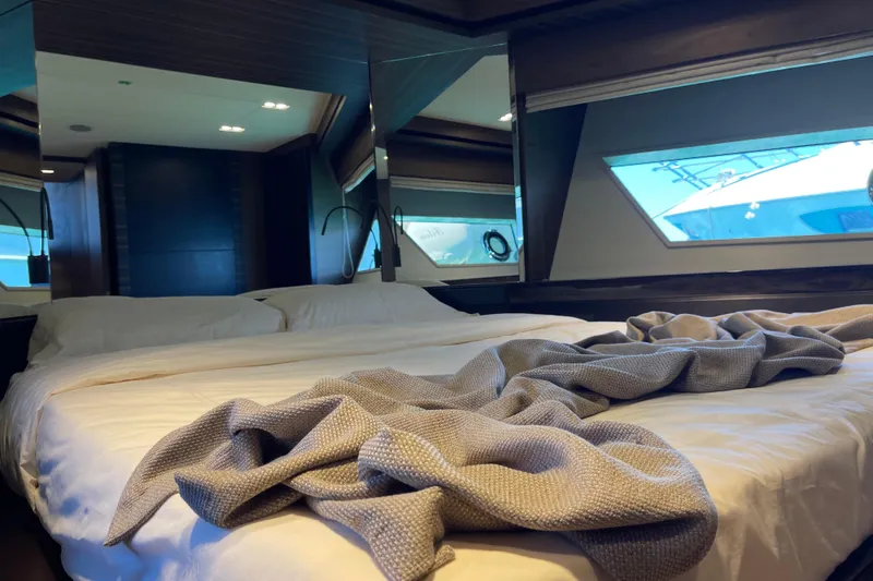  Yacht Photos Pics Luxurious bedroom interior of 2025 Ferretti Yachts 670 with elegant bedding and large windows.