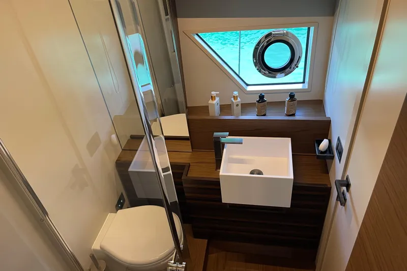  Yacht Photos Pics Luxurious bathroom in 2025 Ferretti Yachts 670, featuring modern sink and ocean view.