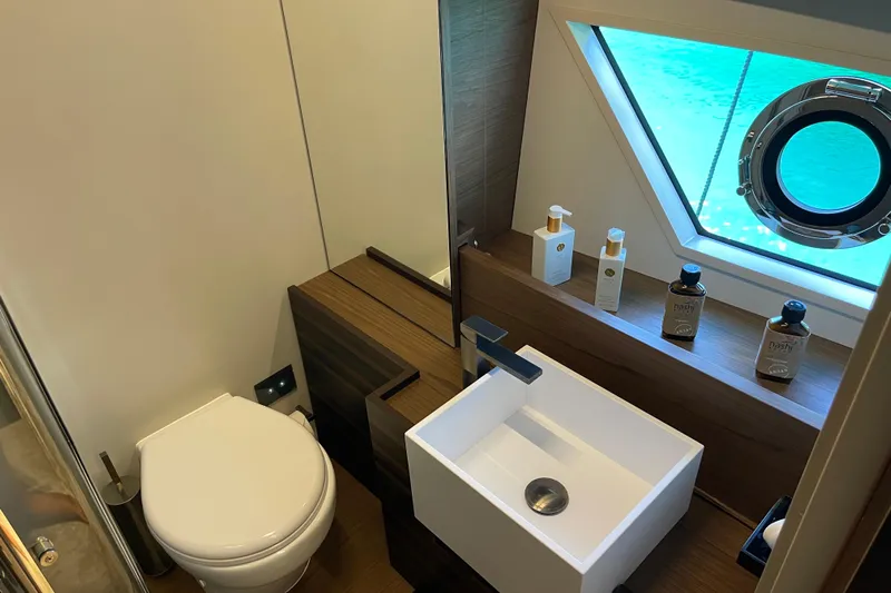  Yacht Photos Pics Luxurious bathroom in 2025 Ferretti Yachts 670, featuring modern sink and ocean view.
