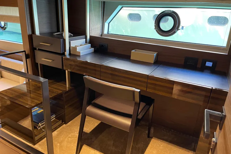  Yacht Photos Pics Luxurious interior of 2025 Ferretti Yachts 670 with elegant desk and window view.