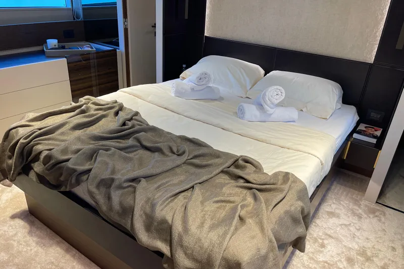  Yacht Photos Pics Luxurious bedroom interior of 2025 Ferretti Yachts 670 with elegant bedding and decor.