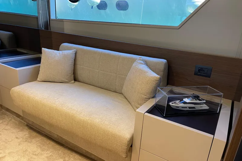  Yacht Photos Pics Luxurious interior of 2025 Ferretti Yachts 670 with model yacht display.