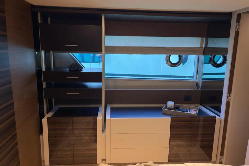  Yacht Photos Pics Luxurious interior of 2025 Ferretti Yachts 670 with modern cabinetry and large window.