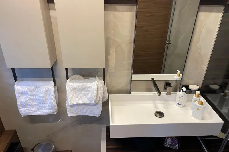  Yacht Photos Pics Modern bathroom in 2025 Ferretti Yachts 670, featuring sleek sink and towels.