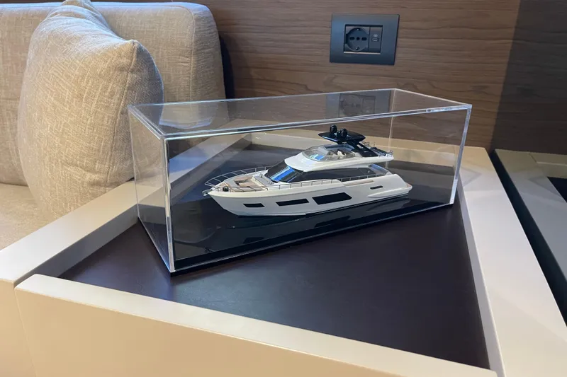  Yacht Photos Pics Model of 2025 Ferretti Yachts 670 displayed in a clear case on a table.