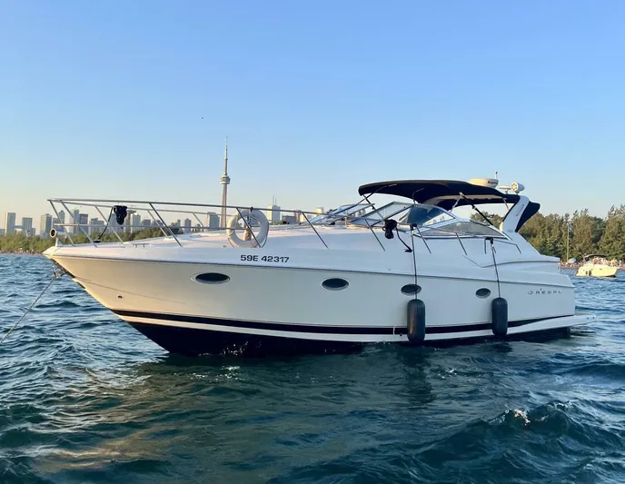  Yacht Photos Pics 2002 Regal 3860 Commodore yacht on water with city skyline in background.