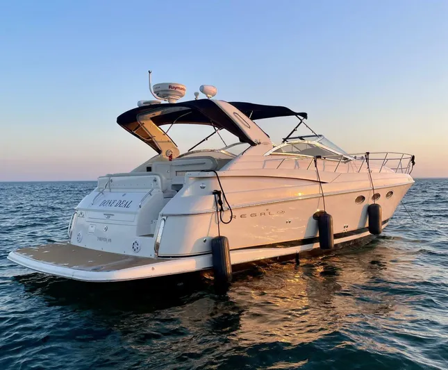  Yacht Photos Pics 2002 Regal 3860 Commodore yacht on open water at sunset.