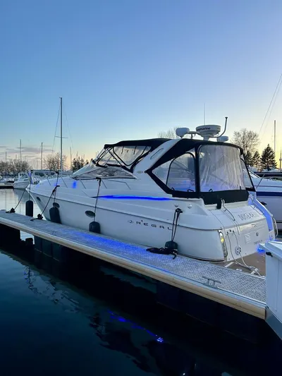  Yacht Photos Pics 2002 Regal 3860 Commodore yacht docked at sunset with blue accent lighting.