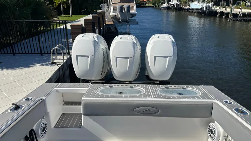  Yacht Photos Pics 2021 Blackwater 36 SF boat with triple outboard engines docked by a canal.