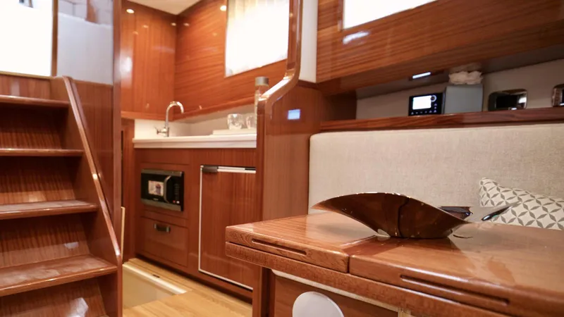 Lancia Aprea Yacht Photos Pics Luxurious interior of 2024 Lancia Aprea 52 yacht with wooden finishes and modern amenities.