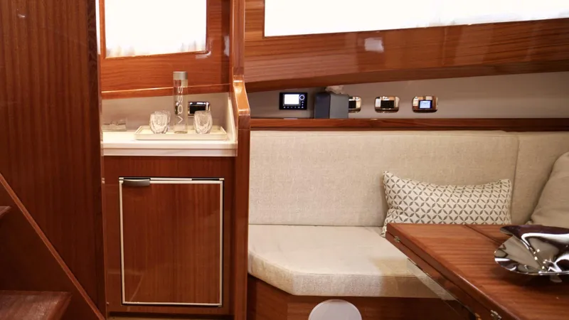 Lancia Aprea Yacht Photos Pics Interior of 2024 Lancia Aprea 52 yacht with elegant wood finish and cozy seating area.