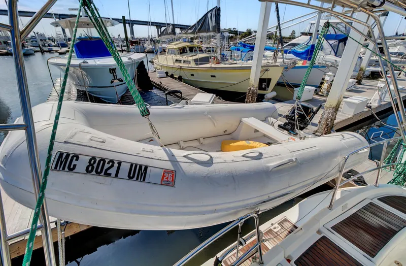 Phantom Yacht Photos Pics Inflatable dinghy on a 2002 Beneteau 473 sailboat, docked at a marina.