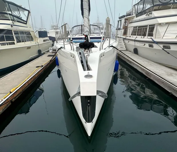 Painkiller Yacht Photos Pics 2020 Bavaria C50 yacht docked between boats in a marina.