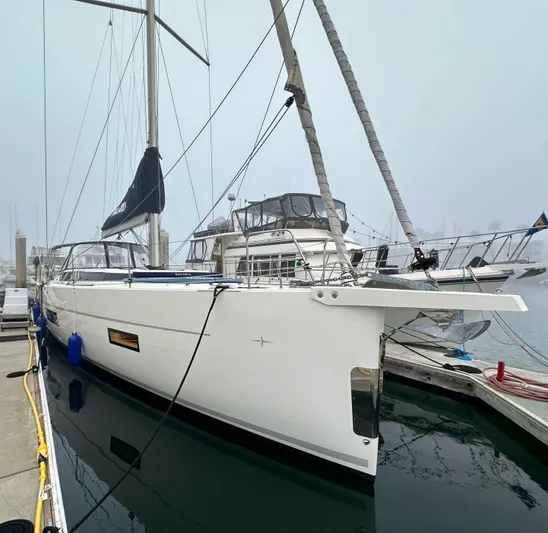Painkiller Yacht Photos Pics 2020 Bavaria C50 yacht docked at marina on a foggy day.