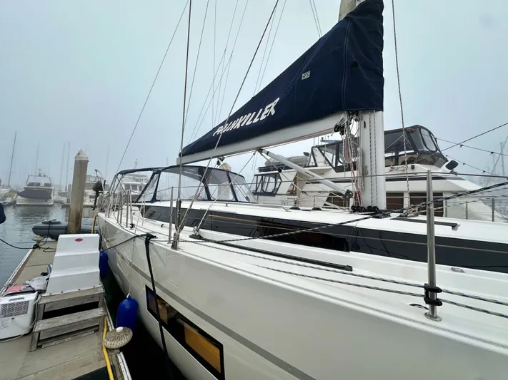 Painkiller Yacht Photos Pics Bavaria C50 yacht docked at marina, 2020 model, with misty background.