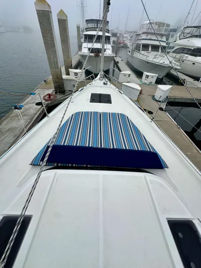 Painkiller Yacht Photos Pics Bavaria C50 yacht docked at marina, 2020 model, with striped deck cover.