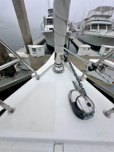 Painkiller Yacht Photos Pics Bow of 2020 Bavaria C50 yacht docked at marina with anchor chain visible.