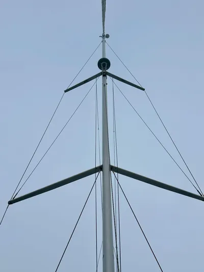 Painkiller Yacht Photos Pics Mast of 2020 Bavaria C50 sailboat against a clear sky.