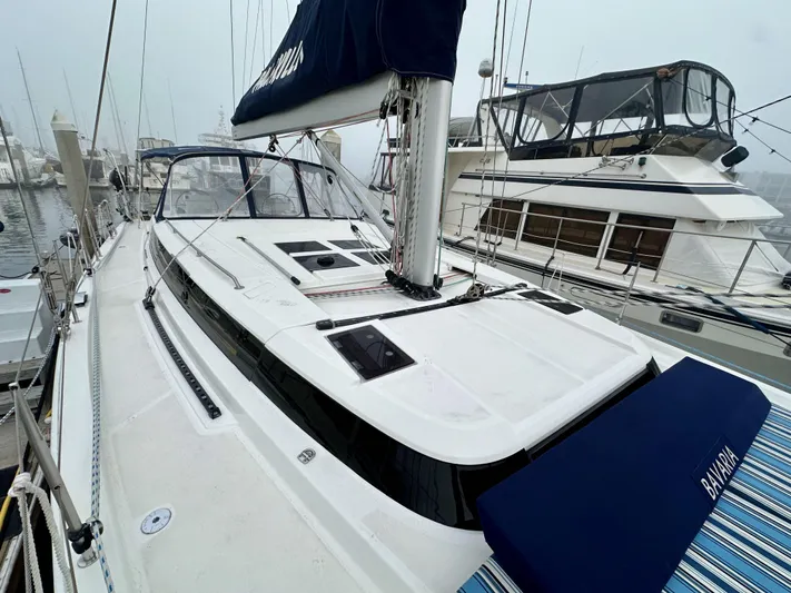 Painkiller Yacht Photos Pics 2020 Bavaria C50 yacht docked at marina, showcasing sleek design and spacious deck.