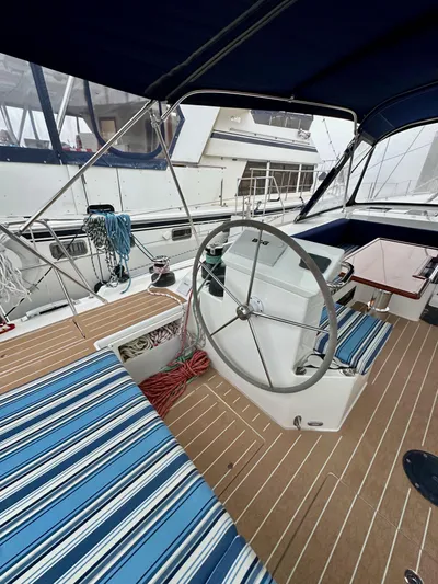 Painkiller Yacht Photos Pics 2020 Bavaria C50 yacht cockpit with striped seating and steering wheel.