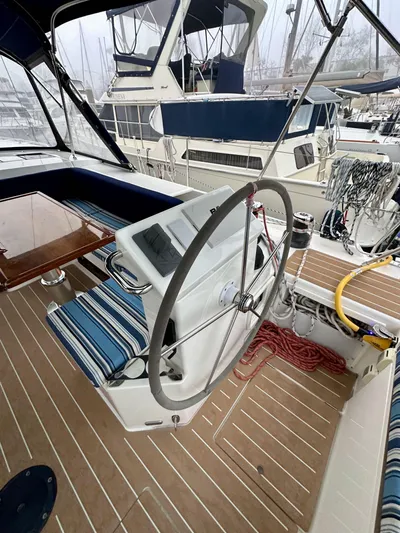 Painkiller Yacht Photos Pics 2020 Bavaria C50 yacht cockpit with steering wheel and striped seating.