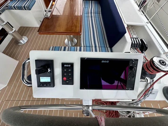 Painkiller Yacht Photos Pics Cockpit of 2020 Bavaria C50 yacht with navigation equipment and striped seating.