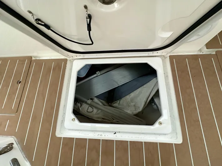 Painkiller Yacht Photos Pics Open hatch on 2020 Bavaria C50 yacht deck, revealing storage compartment.