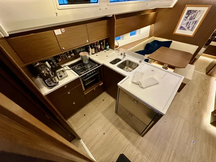 Painkiller Yacht Photos Pics Modern kitchen interior of 2020 Bavaria C50 yacht with sleek cabinetry and appliances.