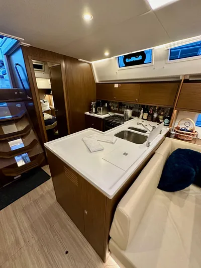 Painkiller Yacht Photos Pics Interior of 2020 Bavaria C50 yacht featuring modern kitchen and seating area.