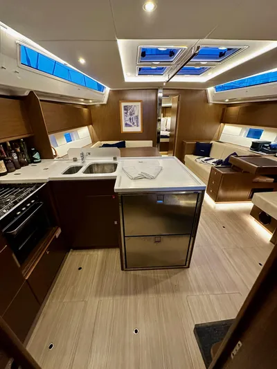 Painkiller Yacht Photos Pics Interior of 2020 Bavaria C50 yacht, featuring modern kitchen and seating area.