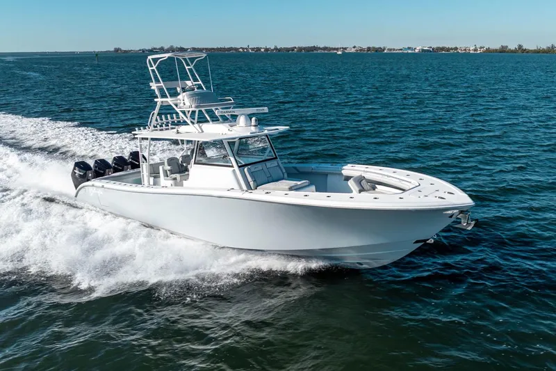  Yacht Photos Pics 2023 Yellowfin 42 Offshore boat cruising on open water, showcasing sleek design and powerful engines.