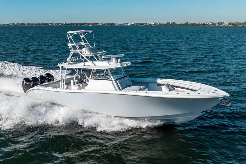  Yacht Photos Pics 2023 Yellowfin 42 Offshore boat cruising on open water, showcasing sleek design and powerful engines.