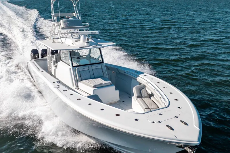  Yacht Photos Pics 2023 Yellowfin 42 Offshore boat cruising on open water, showcasing sleek design and powerful performance.