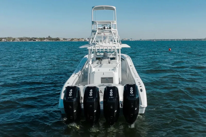  Yacht Photos Pics 2023 Yellowfin 42 Offshore boat with four powerful outboard engines on open water.