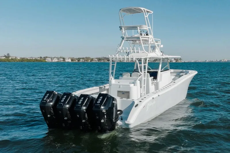  Yacht Photos Pics 2023 Yellowfin 42 Offshore boat with triple outboard engines on open water.