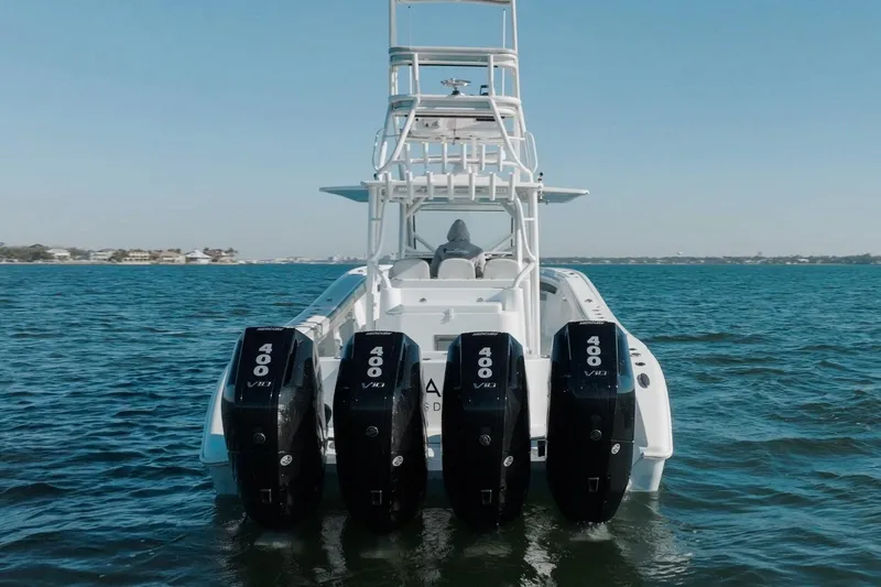  Yacht Photos Pics 2023 Yellowfin 42 Offshore boat with four powerful outboard engines on open water.